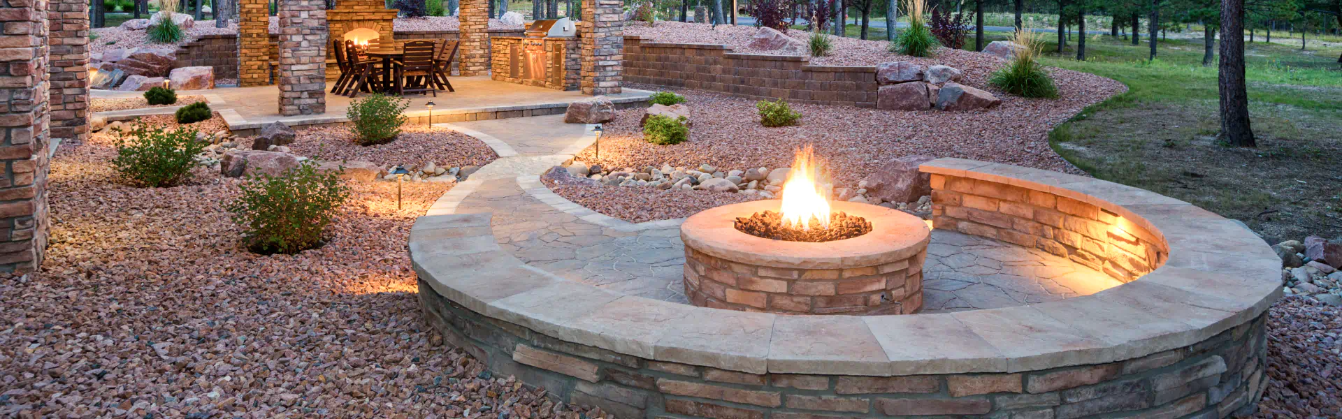 outdoor masonry fireplace and landscape